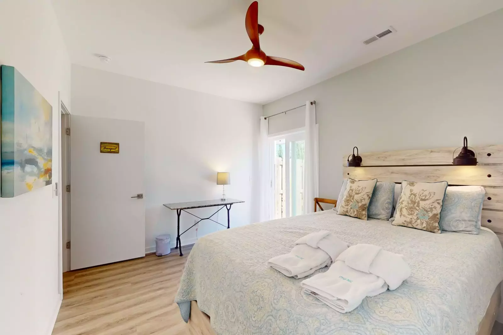 The lovely headboard with mounted lighting make reading in bed a breeze