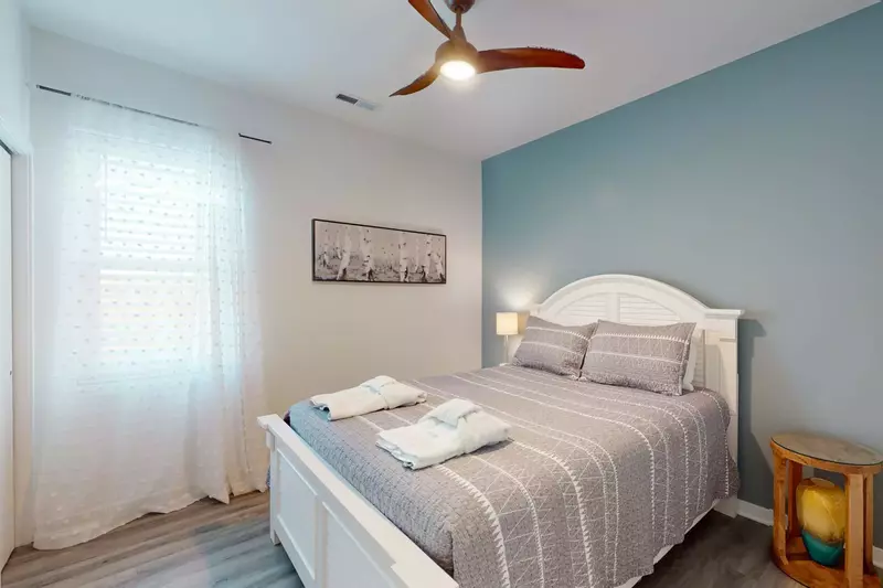 Bedroom #3 has a queen bed and calming accent wall