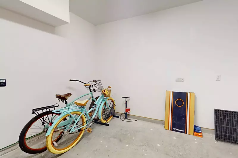 The garage features bikes and cornhole!