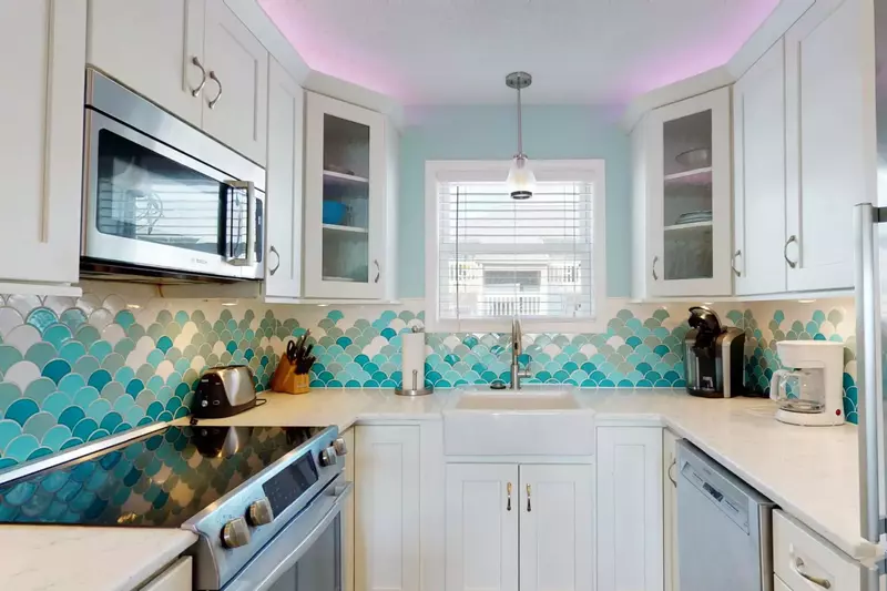 Stunning kitchen tiling with recessed lighting and stainless steel appliances