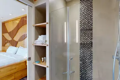 Exquisite European style tile work and built-ins in the walk-in master shower