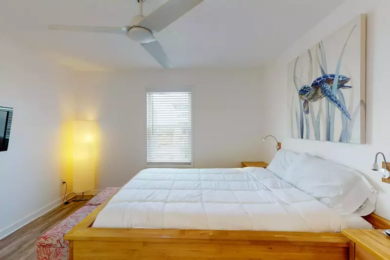 The second bedroom features a queen bed and wall mounted tv