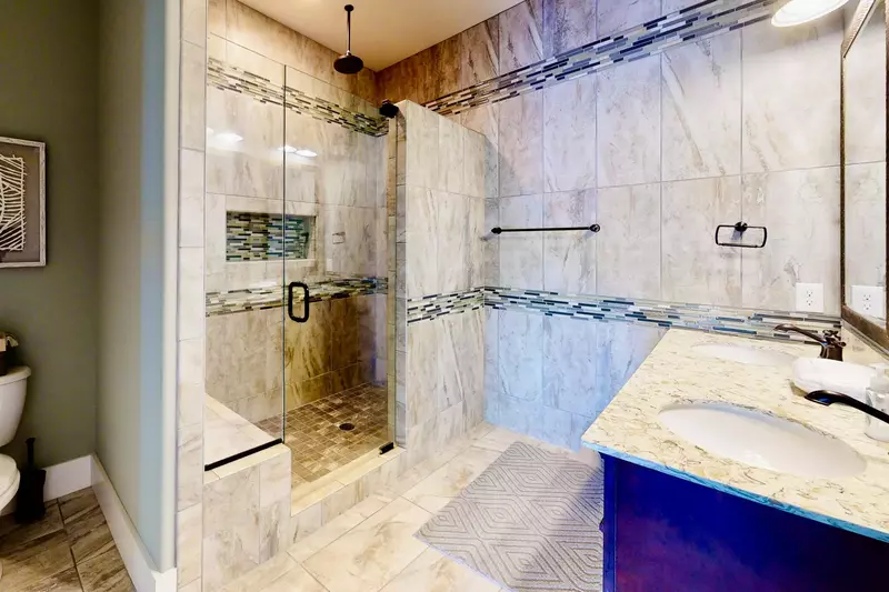 Owner suite has a custom tiled bathroom