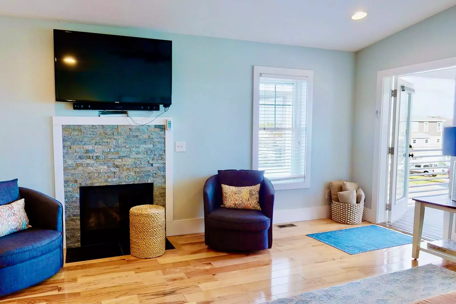 Living room features a large screen tv and fireplace