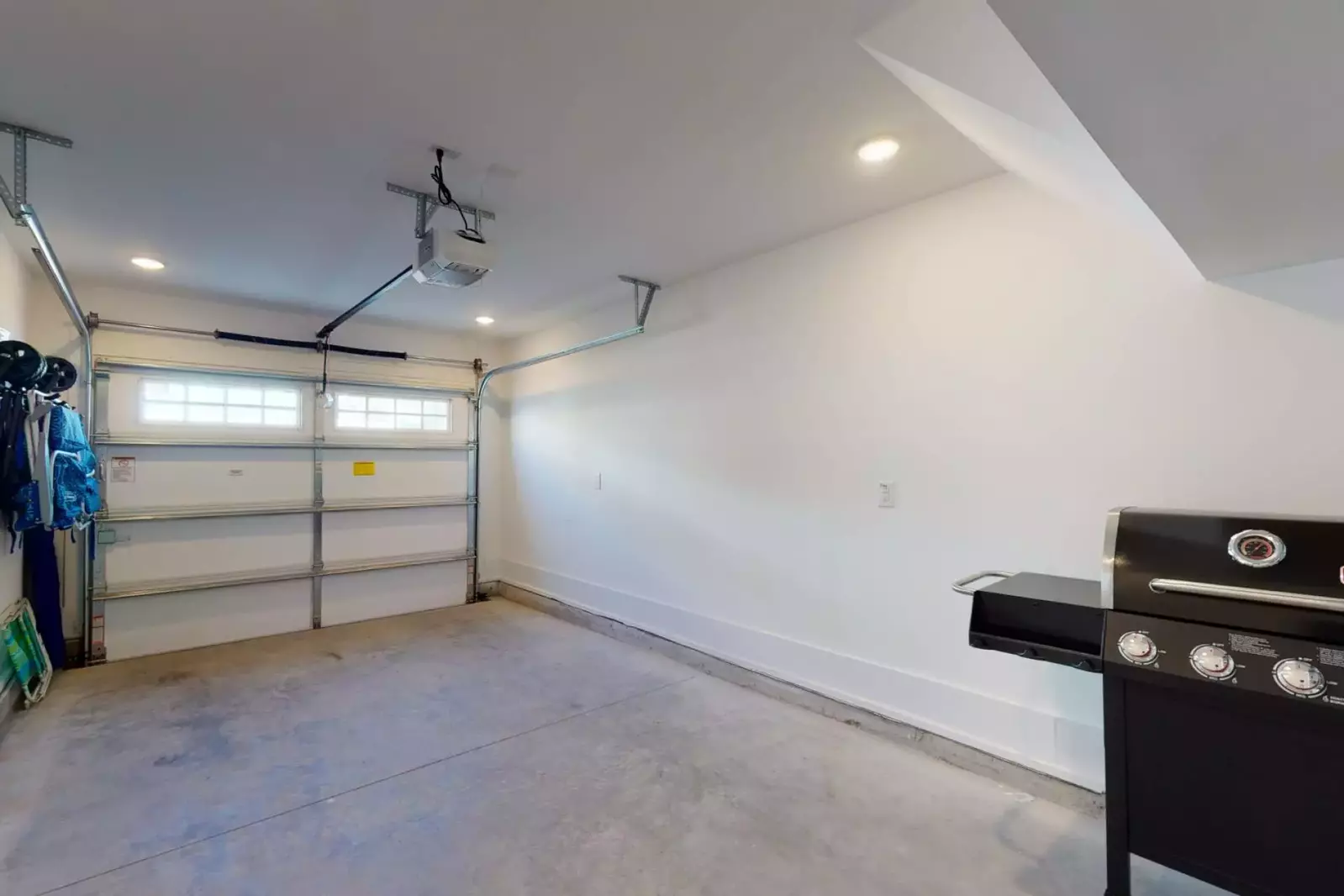 Garage with beach chairs and grill