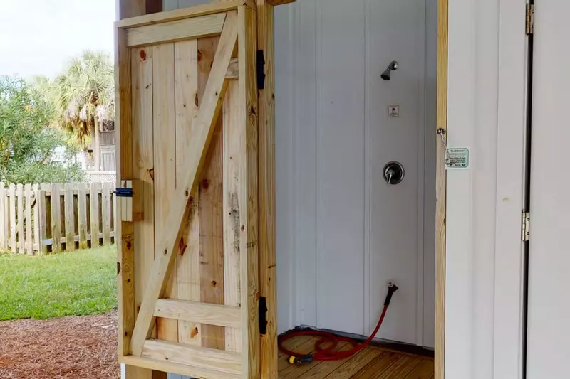 Rinse off in the private outdoor shower after a fun day at the beach