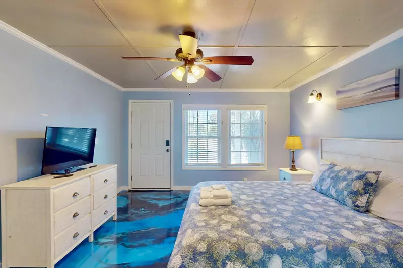 The custom floor in the first floor owner's suite offers the perfect beach vacay feel