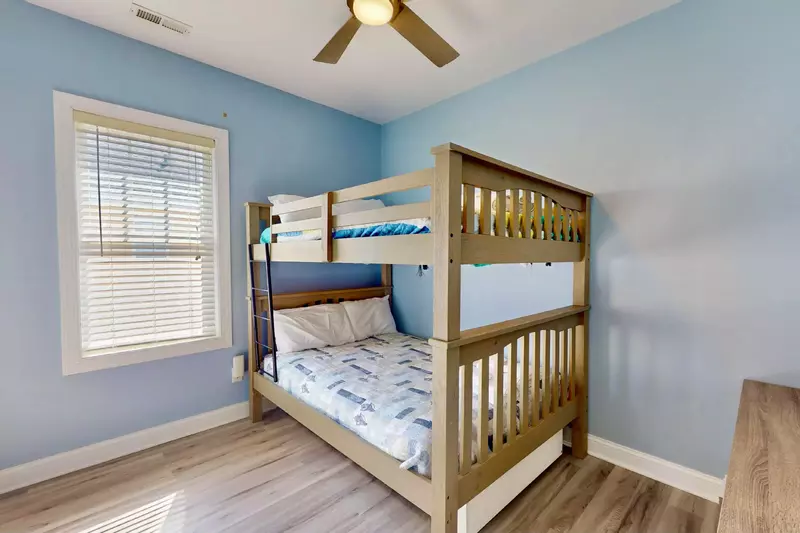 Full sized bunk bed with twin sized trundle underneath the bunks