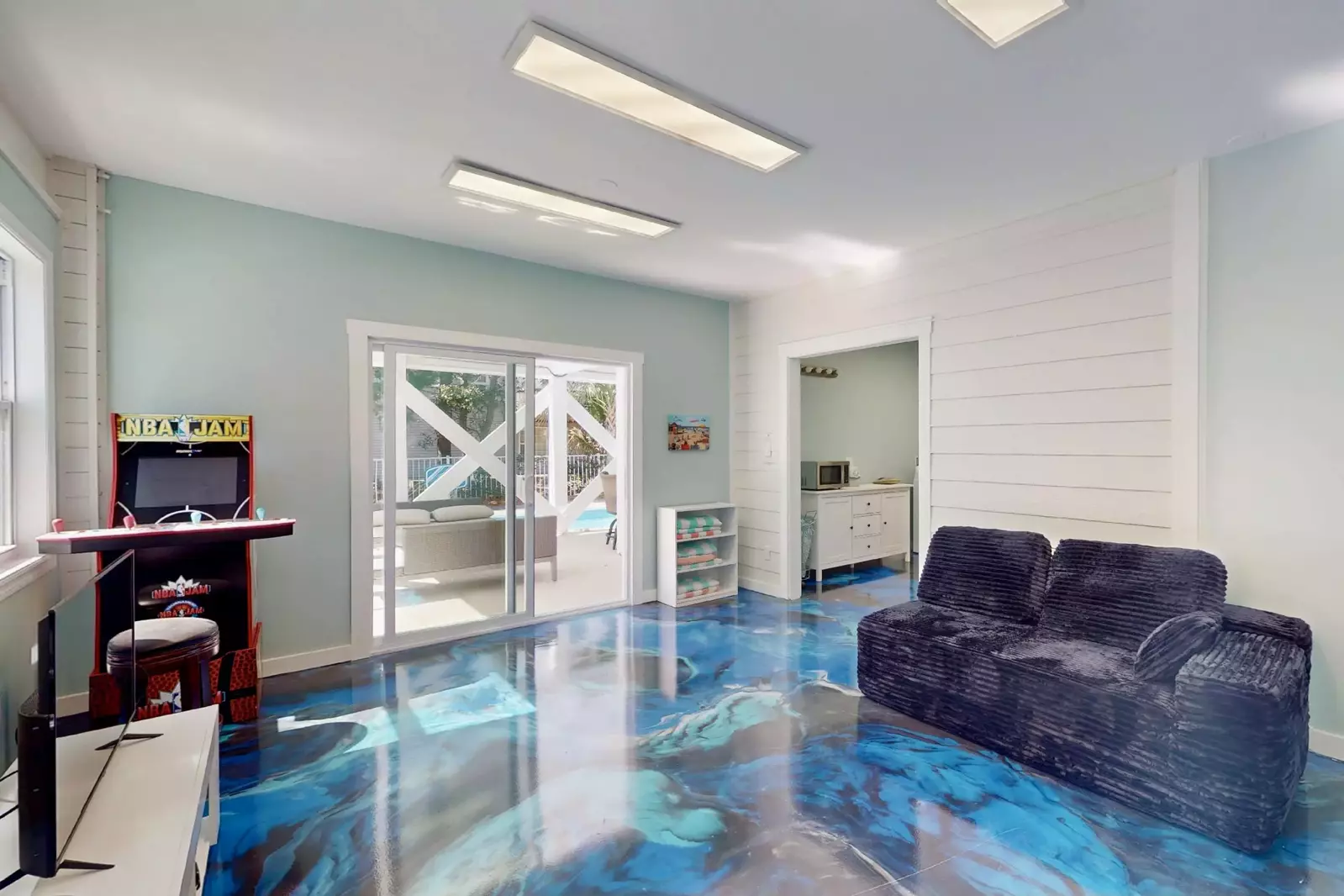 The game room has a custom floor and is a perfect hang out space!