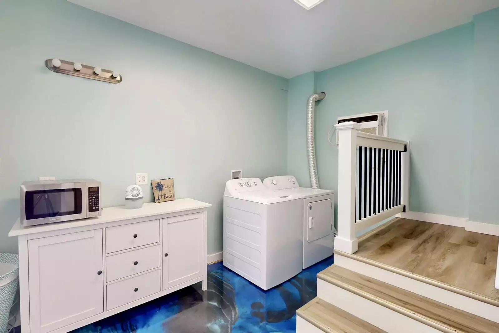 The first floor has a laundry area with an extra microwave