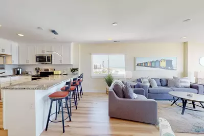 The updated kitchen features a breakfast bar with seating
