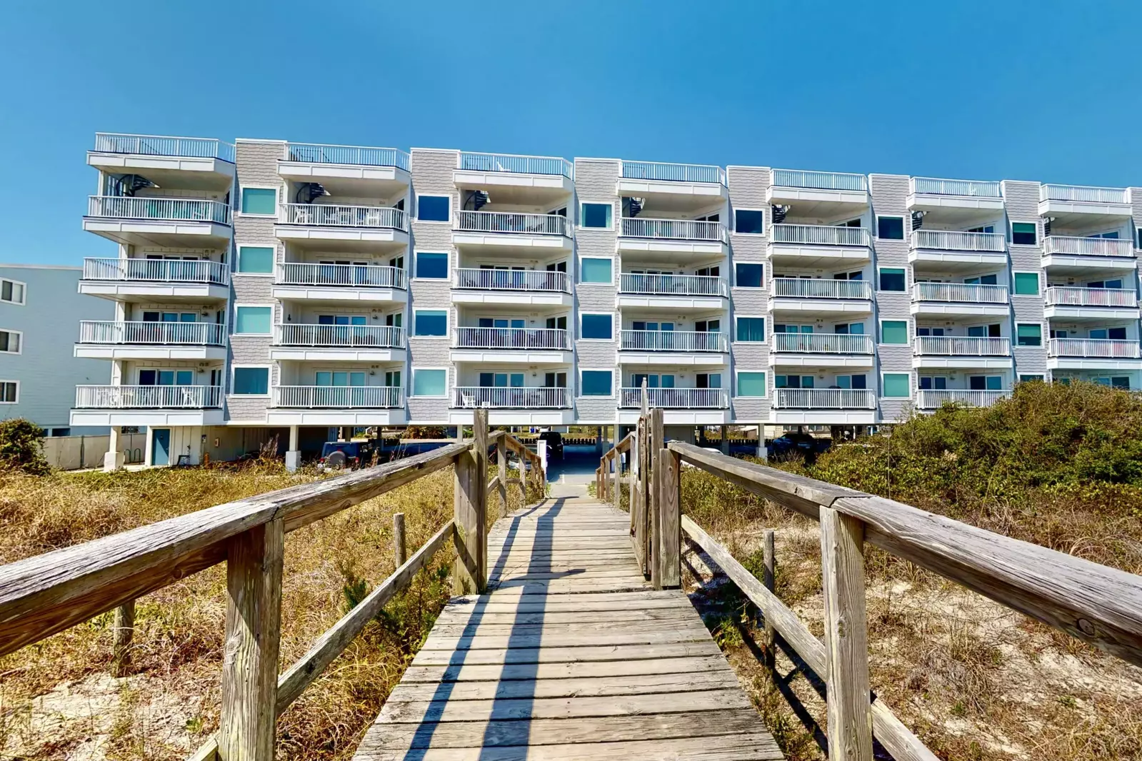 The private beach walkway will have your toes in the sand in seconds