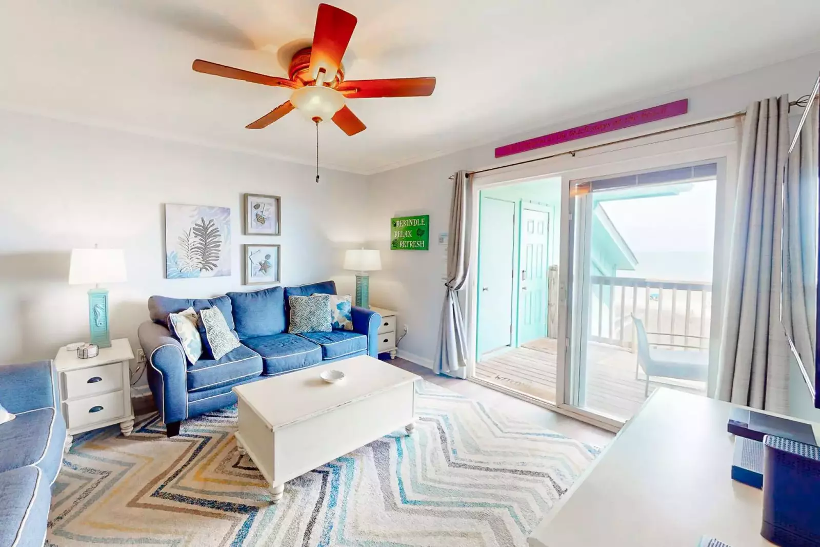 Enjoy the sounds of the ocean in this spacious, comfortable living room with recently updated flooring and new paint