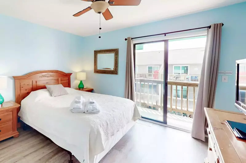 Second bedroom features a queen bed, private deck and Roku TV