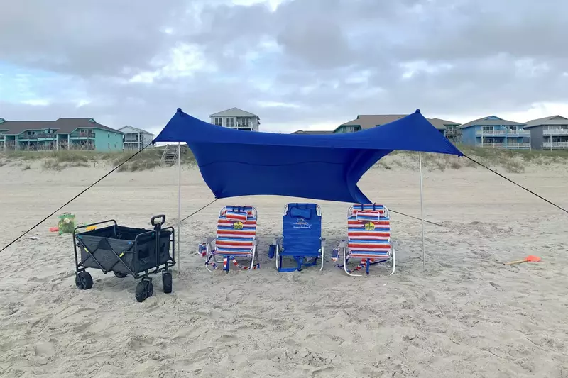 Complitmentary beach chairs, tent, wagon, and various toys and flotation devices for kids.