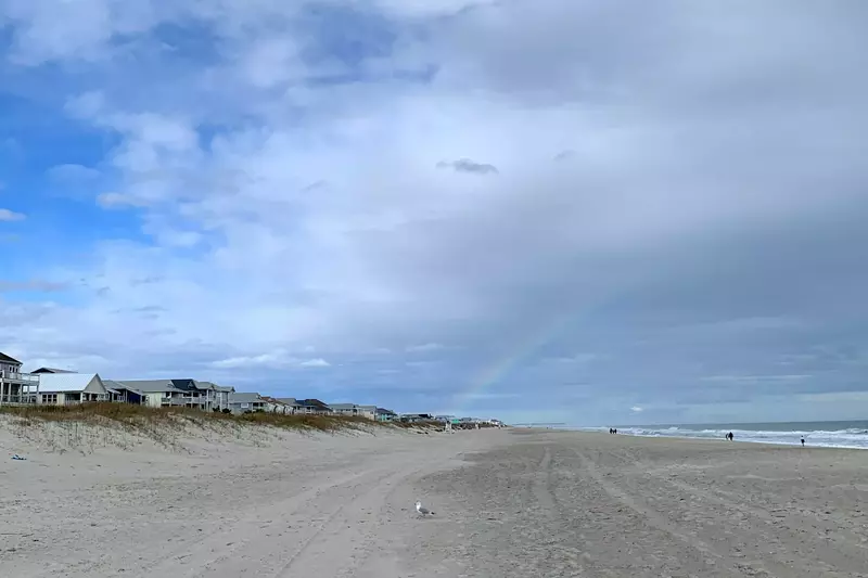 Beautiful wide open beach that you might even see a rainbow on.