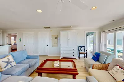 Comfortable and bright living room! Don't worry, there's a tv tucked in that cabinet.