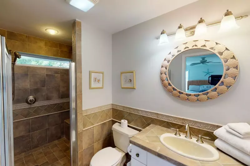 The 1st master bathroom is spacious and has a huge tiled shower