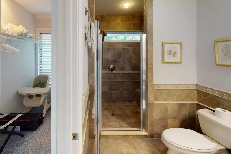 Just outside the 1st master bathroom there is a storage room with a highchair and pack-n-play