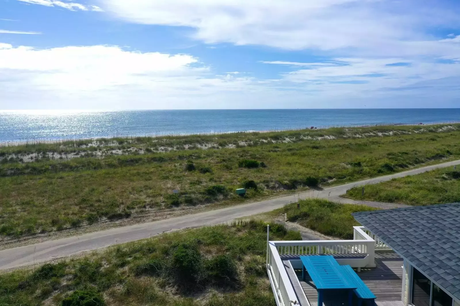 Relax around the large table and enjoy a meal with ocean breezes
