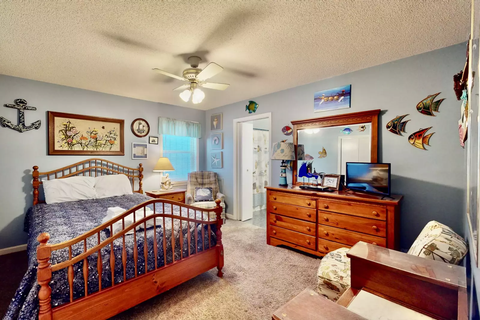 Bedroom 2 features a queen bed and a nautical theme