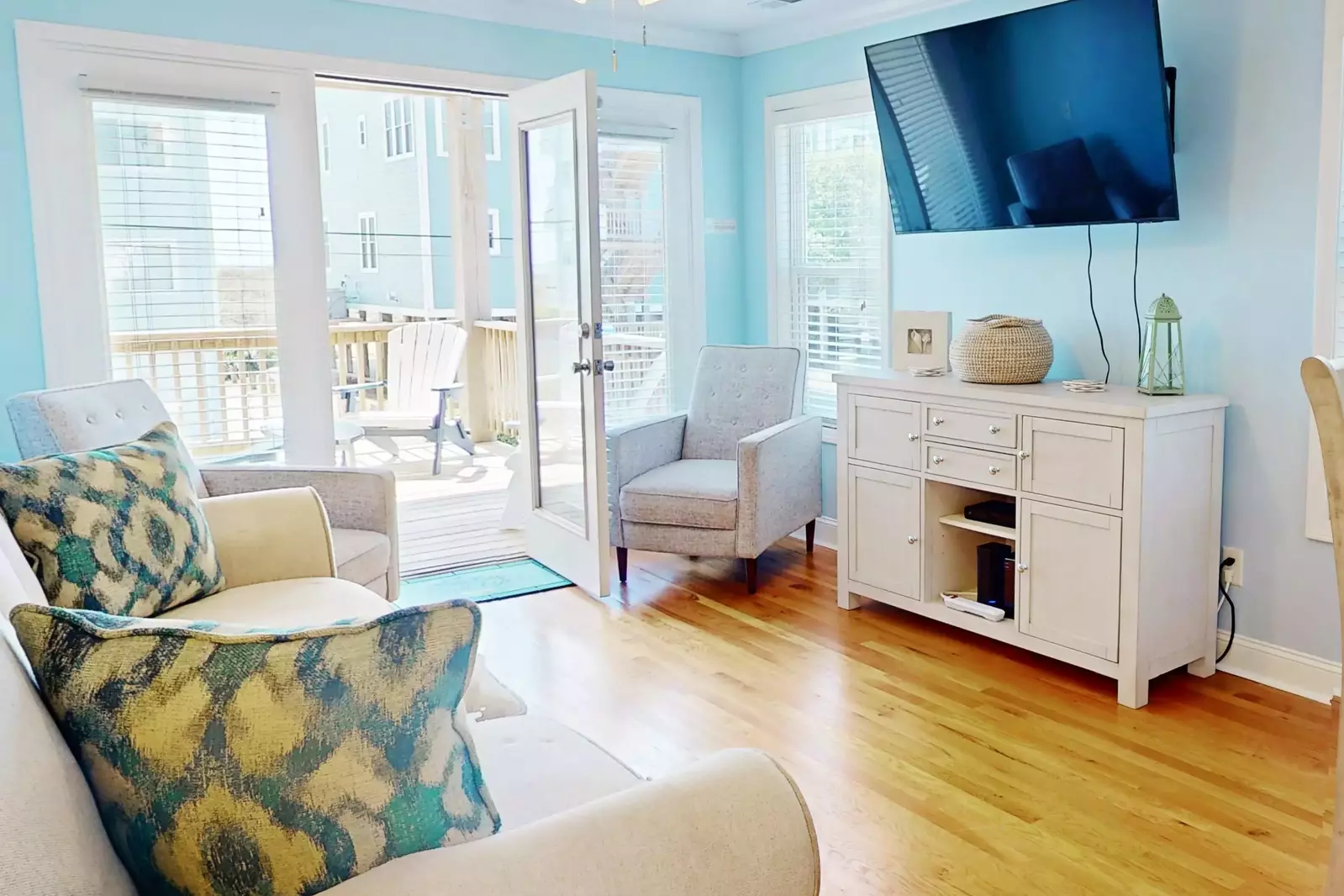 The living room has plenty of natural light and comfy places to sit!