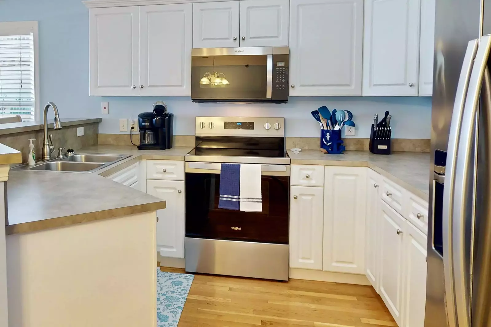 This bright kitchen with new stainless steel appliances has all the space you need make a great meal