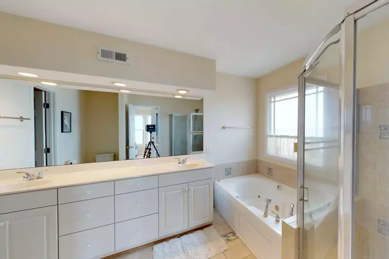 Double sink and soaking bath in the master bedroom.