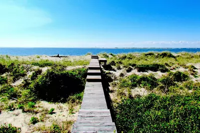 Less than 100 yards your feet are in the sand.  Ocean Front, You betcha!
