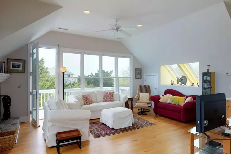Bright and spacious living area with deck access
