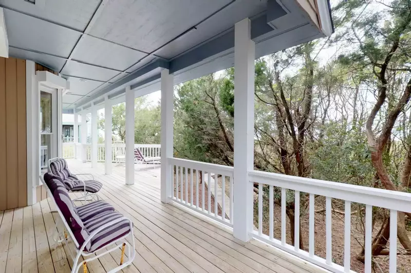 1st floor deck is surrounded by foliage allowing for bedroom privacy or a quiet place to finish a good book