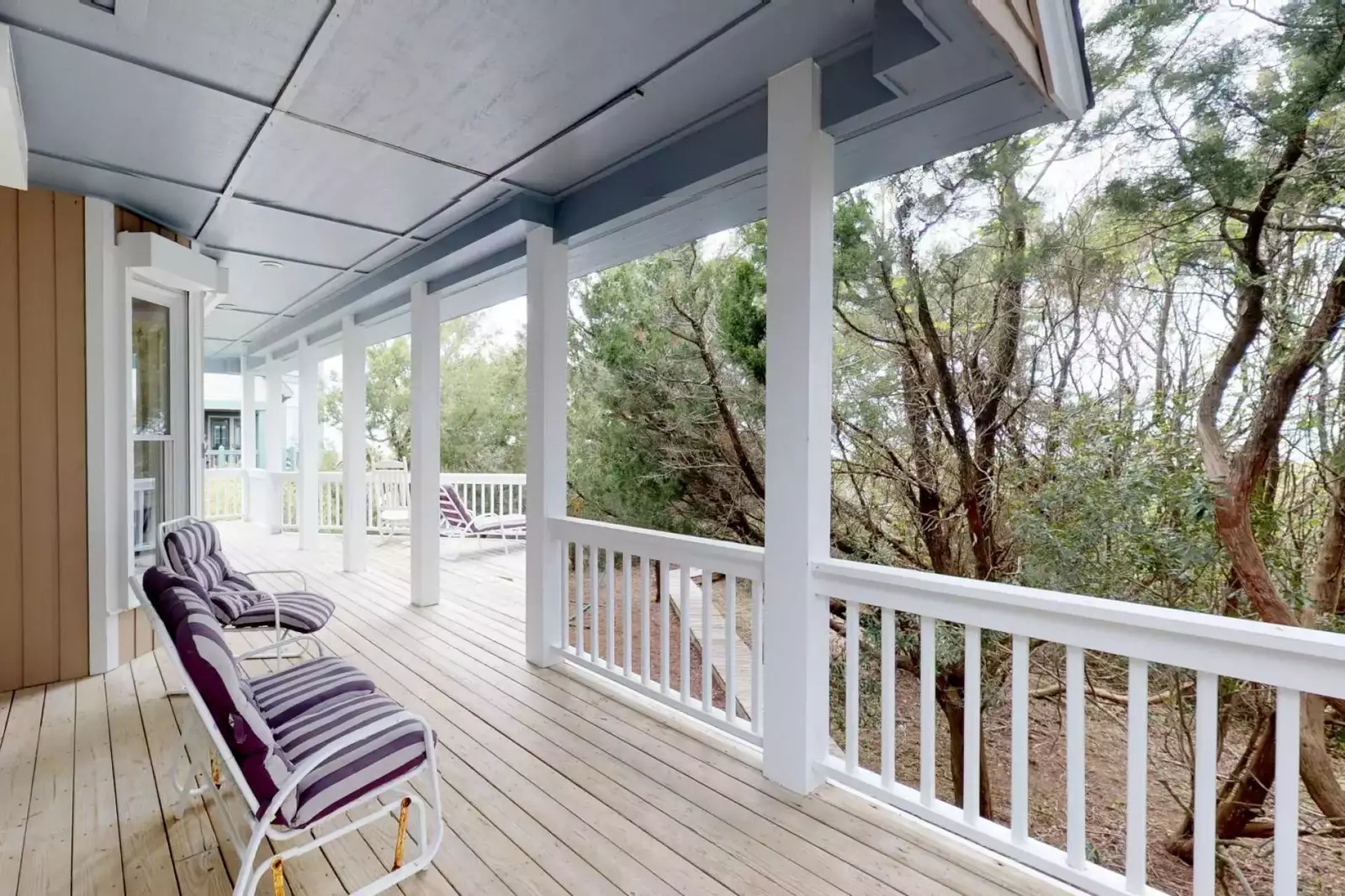 1st floor deck is surrounded by foliage allowing for bedroom privacy or a quiet place to finish a good book