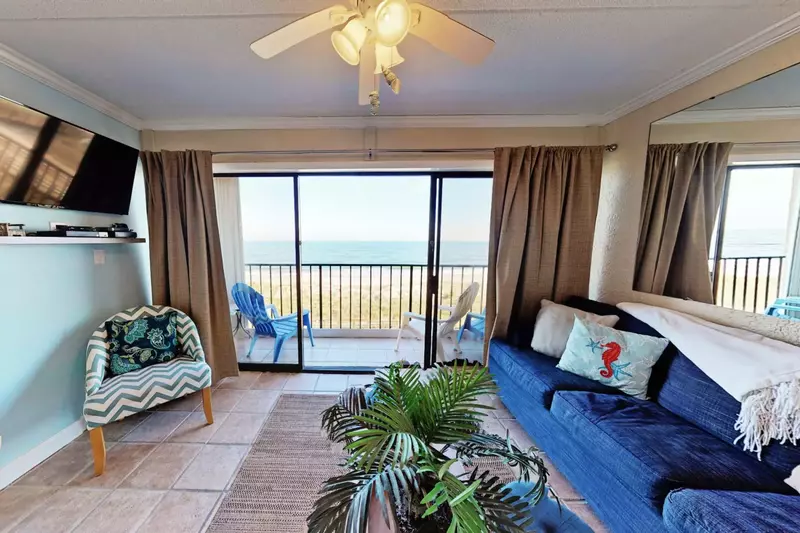 Relax in a beautiful living room area with a great view of the ocean.
