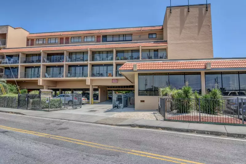 Street view of the condo building where the entrance is for the parking area.