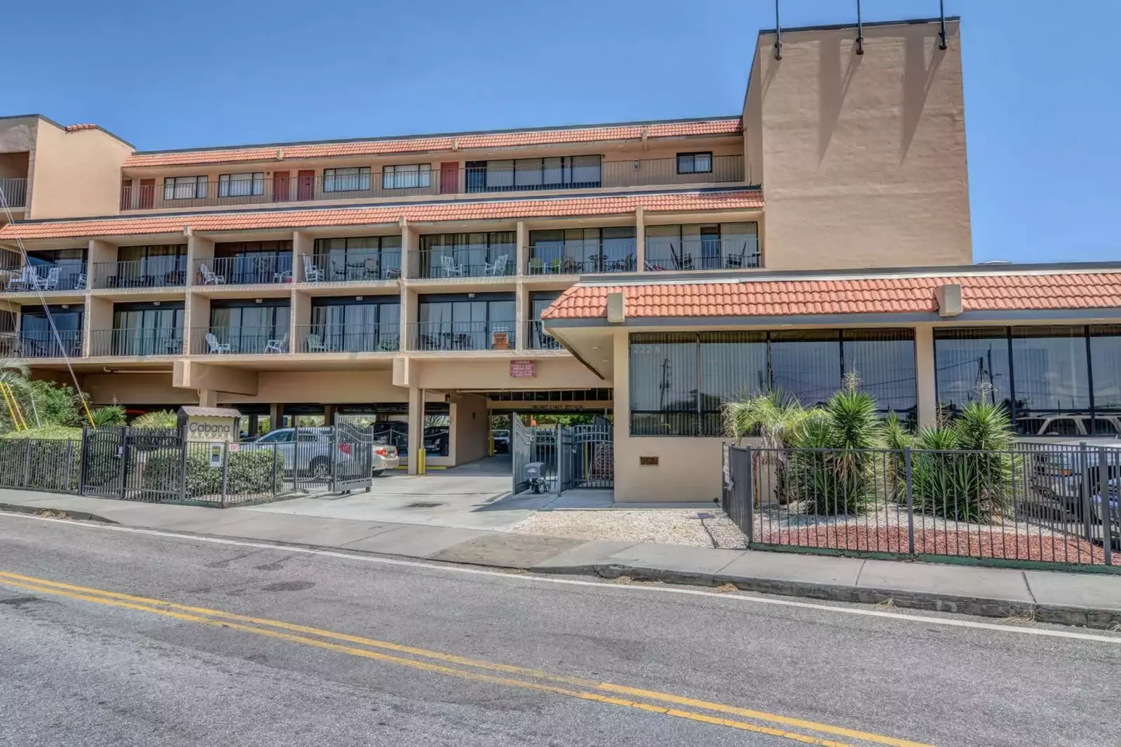 Street view of the condo building where the entrance is for the parking area.