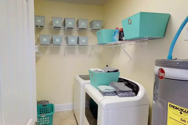 Roomy laundry room with large appliances.