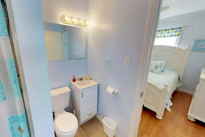 The bathroom has easy access from both bedrooms.