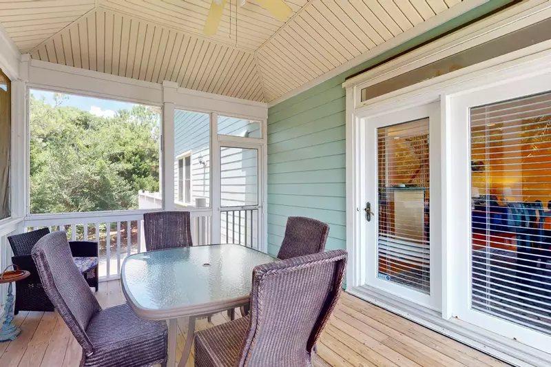 The secluded screened porch opens into the dining area and kitchen
