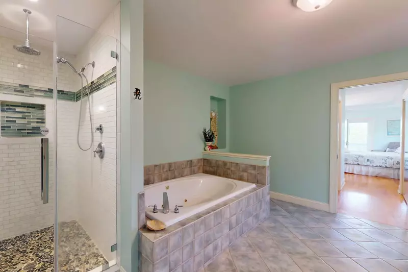 The master bath features a large walk in shower and an oversized tub