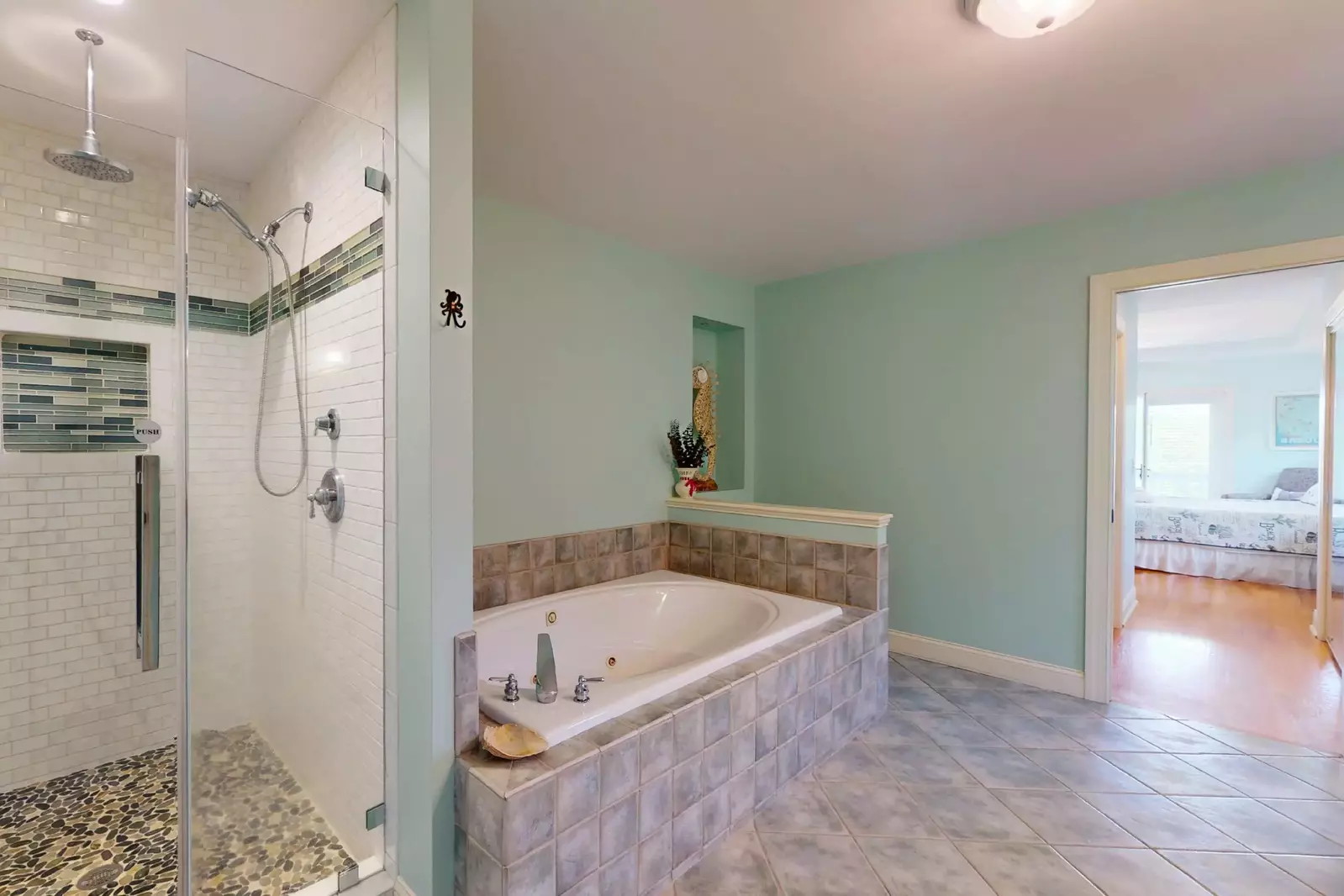 The master bath features a large walk in shower and an oversized tub