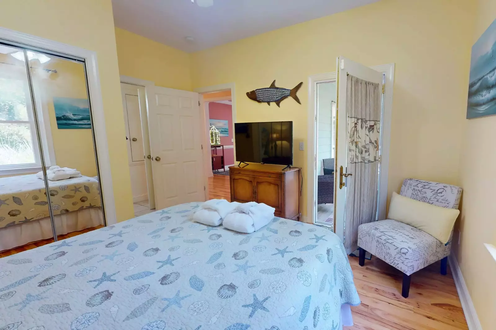 Main floor bedroom with a queen bed and flat screen tv