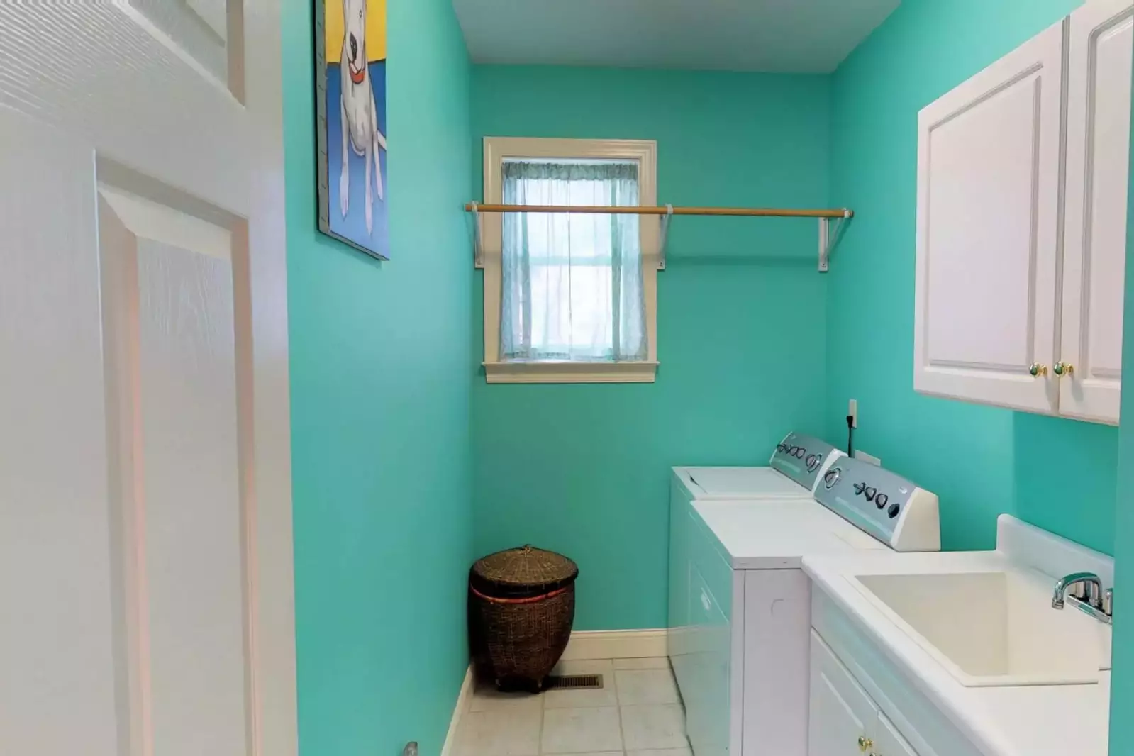 A roomy laundry room is available with a large wash sink.