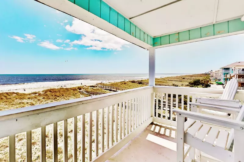 Relax on the deck and watch the sunrise with the best views in Carolina Beach in this end unit