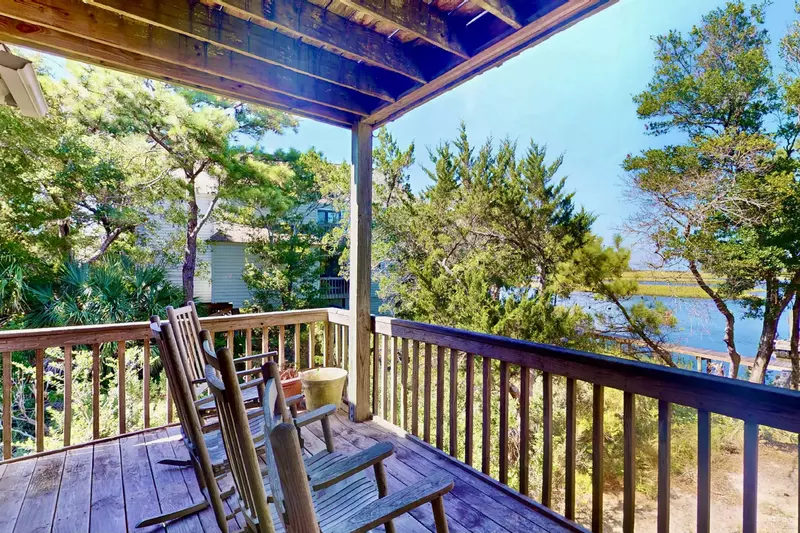 The master bedroom has a private deck with a great view of Bald Head Creek