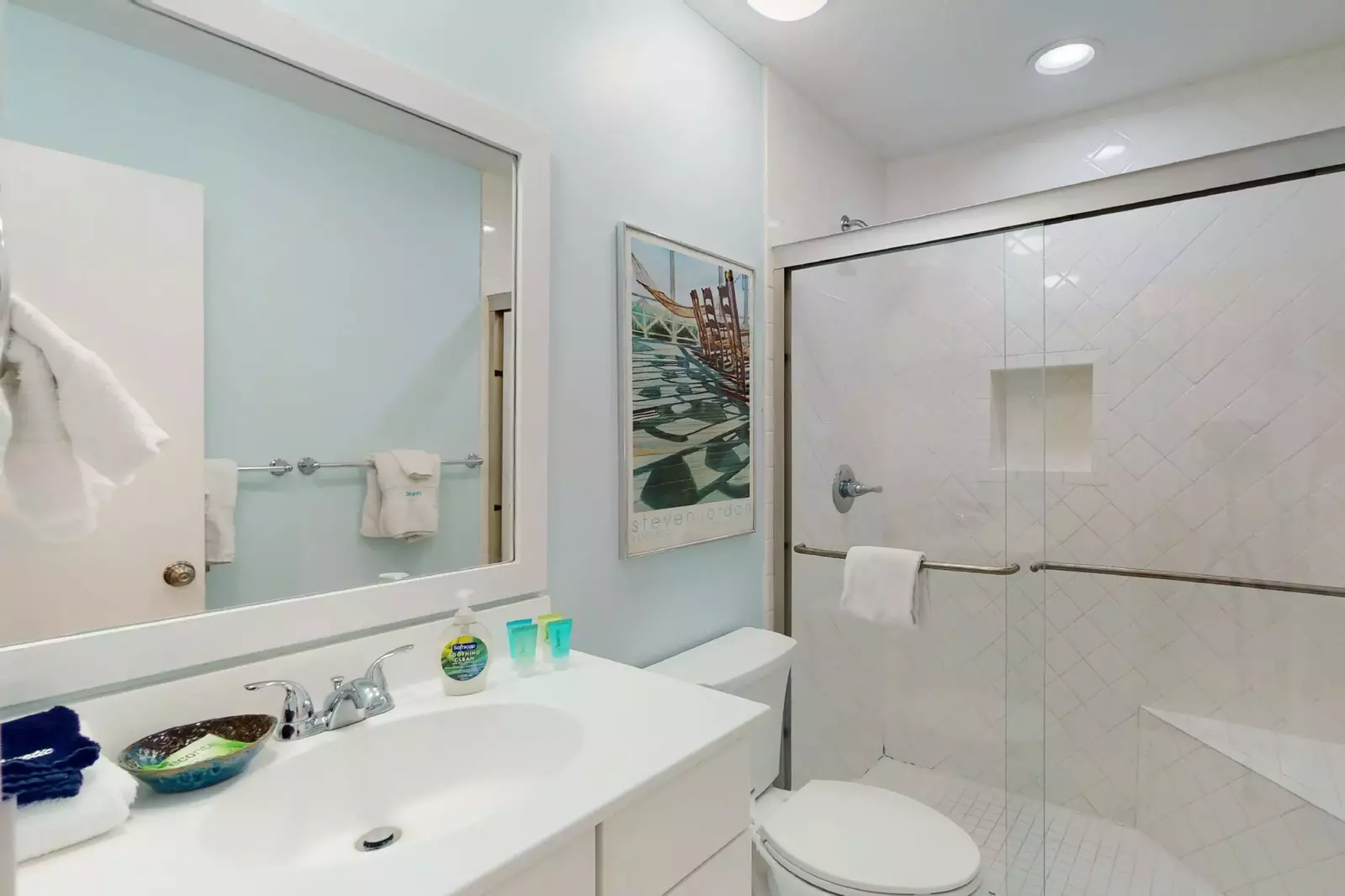 The shared full bathroom with a walk in shower has easy access for the 2nd and 3rd bedroom