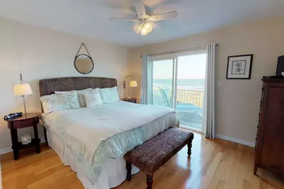 On the top floor the master bedroom has its own private deck entrance and view of the ocean