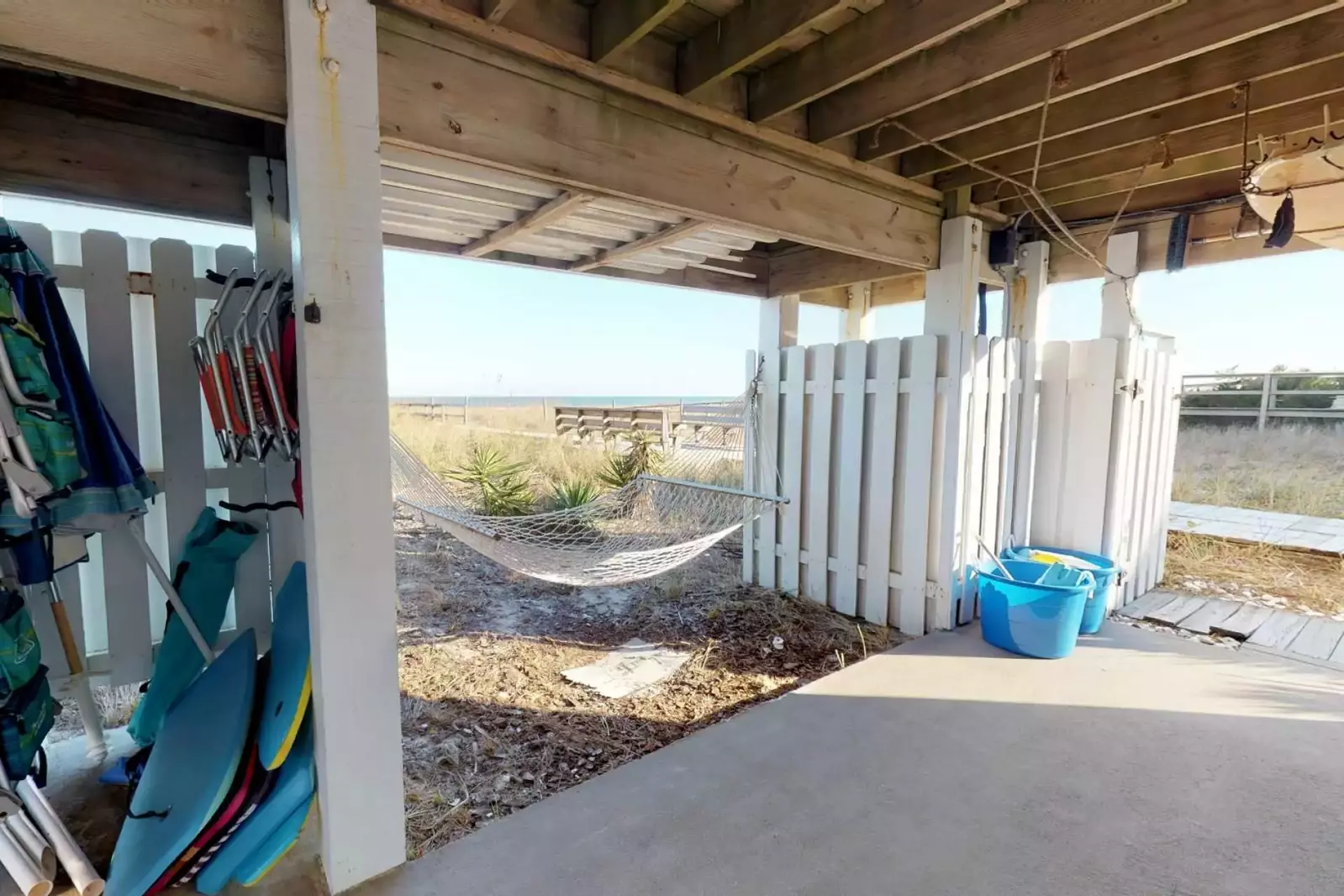 The property comes fully equipped with beach chairs, boogie boards, and the two buckets on the right are filled with beach toys for the kids!