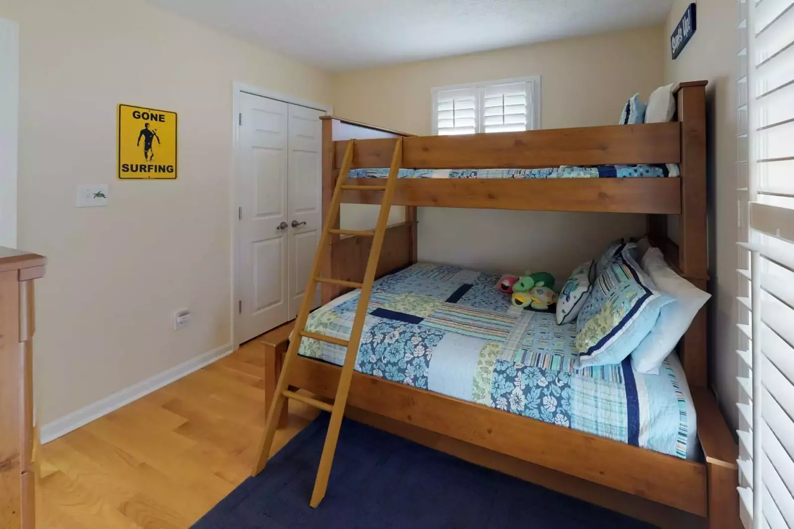3 kids can fit in this bunk bed room located on the top floor. The bottom bed is a full and the top is a twin