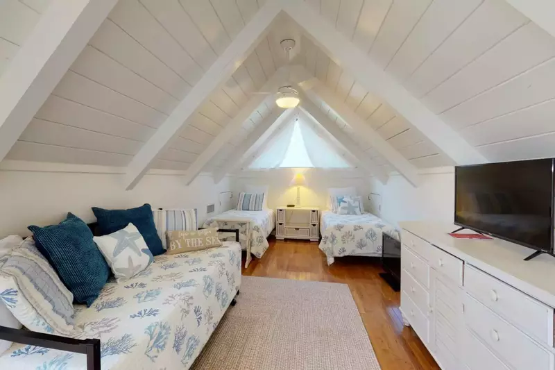 Take the spiral staircase up to the loft with 2 twins and a twin trundle bed. The perfect place for the kids to hang out