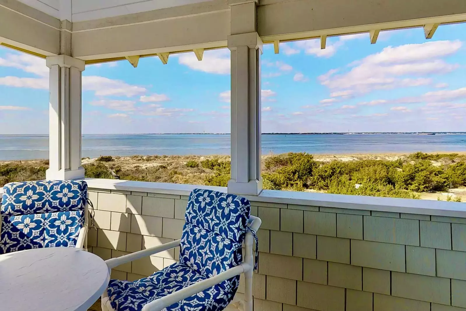 Relax on the covered porch and enjoy the sound of the ocean